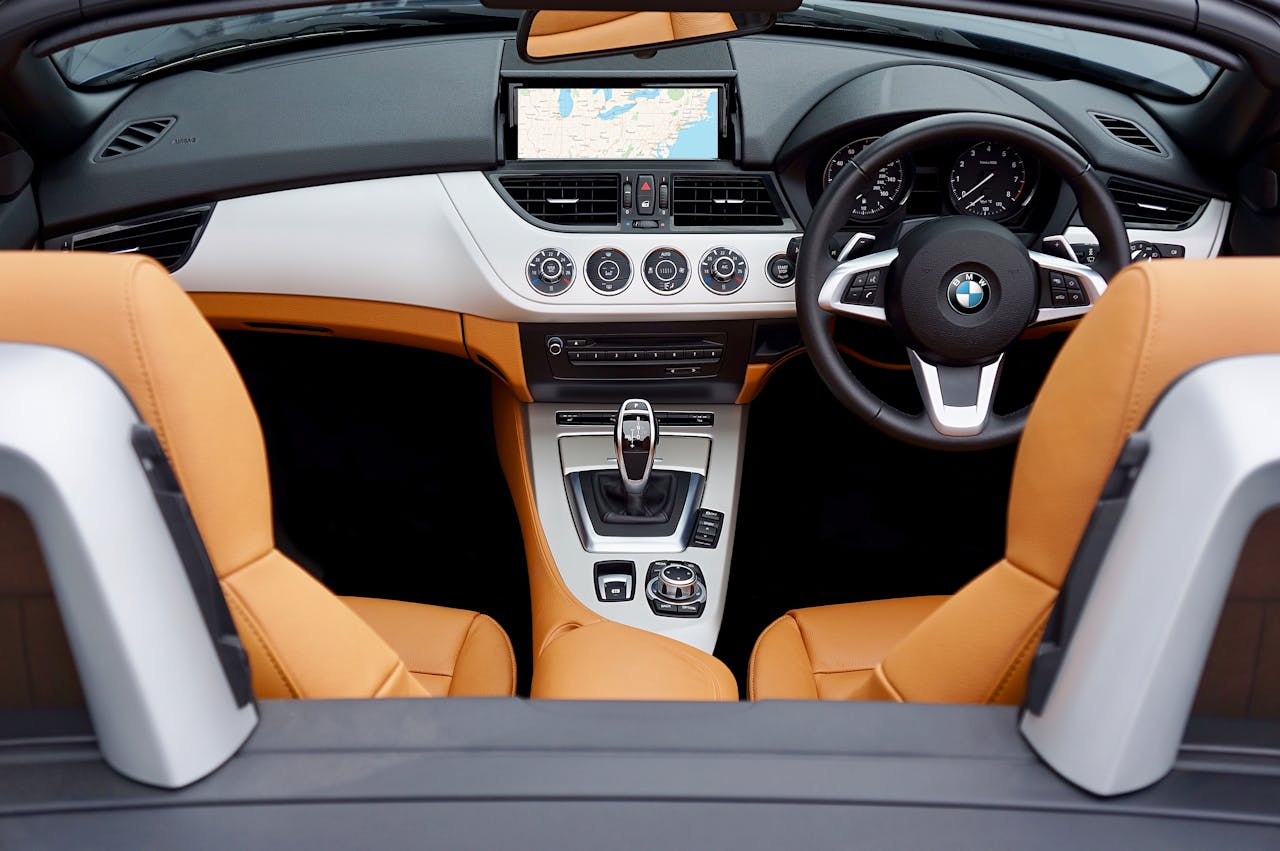 Explore the modern interior of a BMW convertible with leather seats and advanced features.