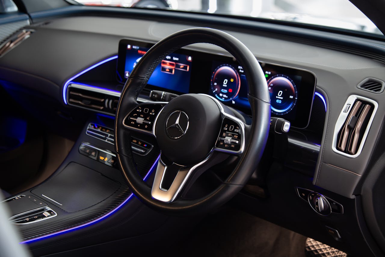 Close-up view of a luxury Mercedes-Benz car interior featuring a sleek dashboard and modern technology.